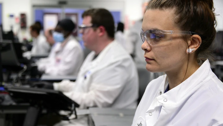 Group of scientists at working station