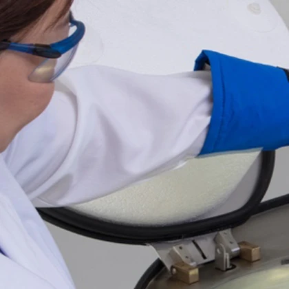 Lab staff handling labware atop a LN2 freezer tank