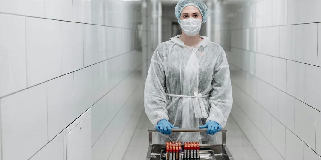 Lab assistant carrying sample tubes