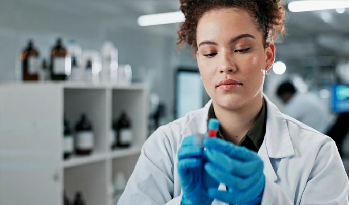 Lab technician applying label on a sample tube